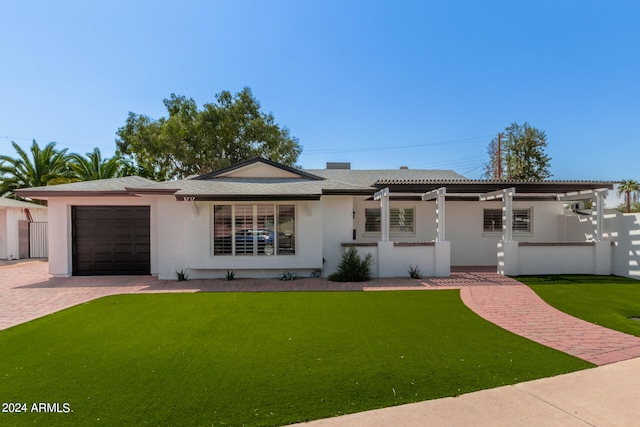 single story home with a garage, a front yard, and a pergola