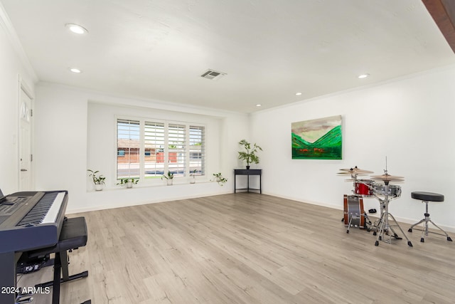 interior space featuring light wood-type flooring and crown molding