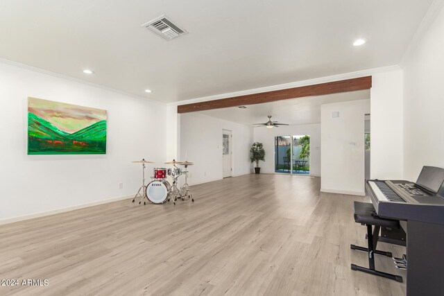 interior space featuring ceiling fan, crown molding, and light hardwood / wood-style flooring