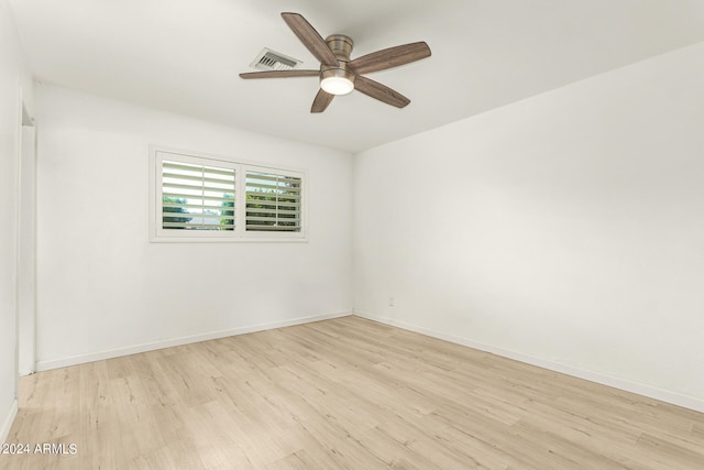 empty room with ceiling fan and light hardwood / wood-style floors