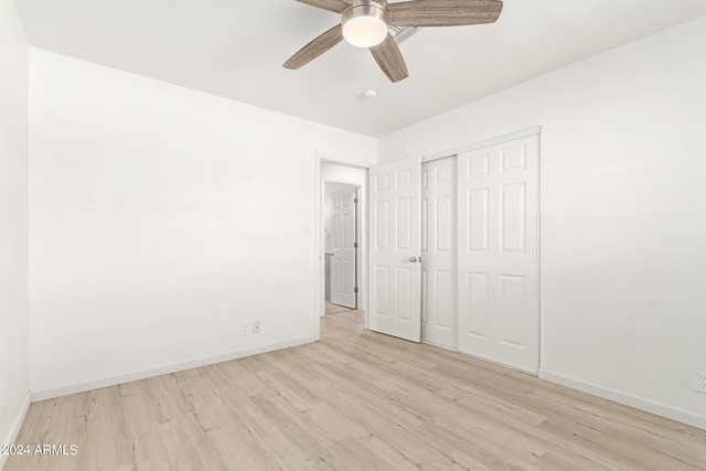 unfurnished bedroom featuring a closet, ceiling fan, and light hardwood / wood-style flooring