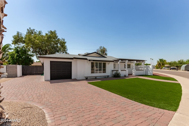 ranch-style home with a front yard and a garage