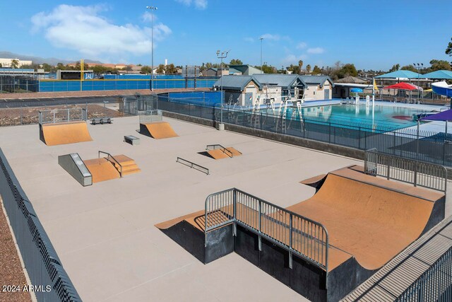 exterior space with a swimming pool and fence