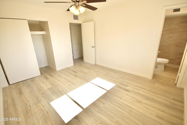 unfurnished bedroom with connected bathroom, light hardwood / wood-style flooring, a closet, and ceiling fan