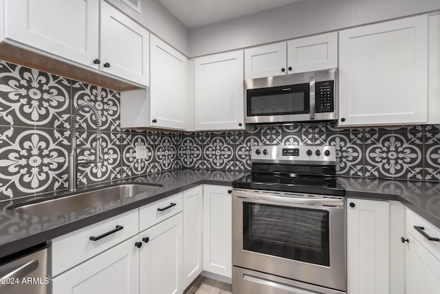 kitchen with stainless steel appliances and white cabinetry