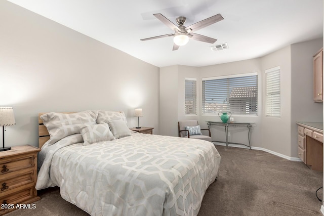 bedroom featuring a ceiling fan, visible vents, dark carpet, and baseboards