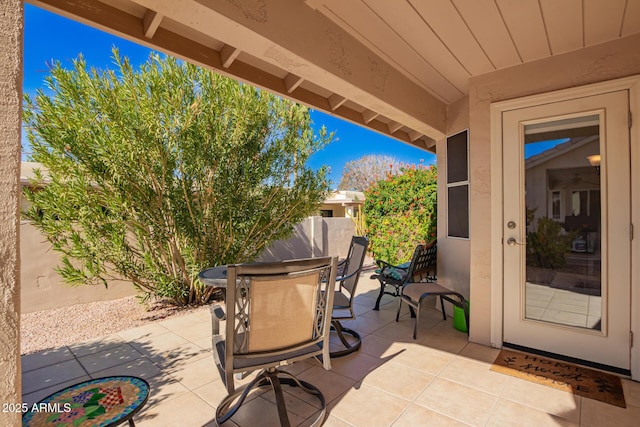 view of patio with fence and outdoor dining area