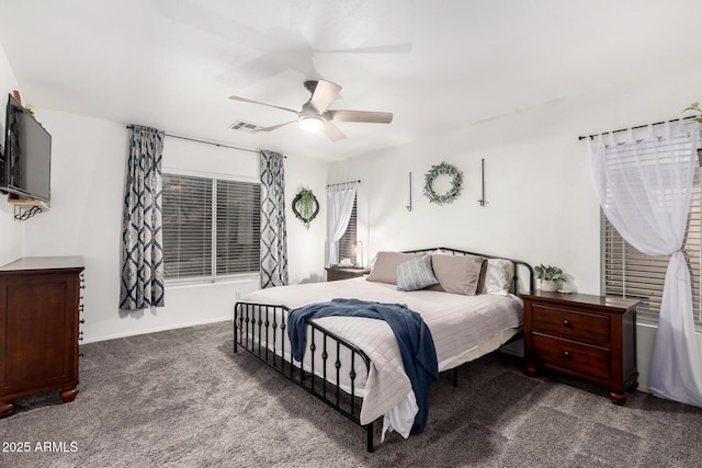 bedroom with dark colored carpet and ceiling fan