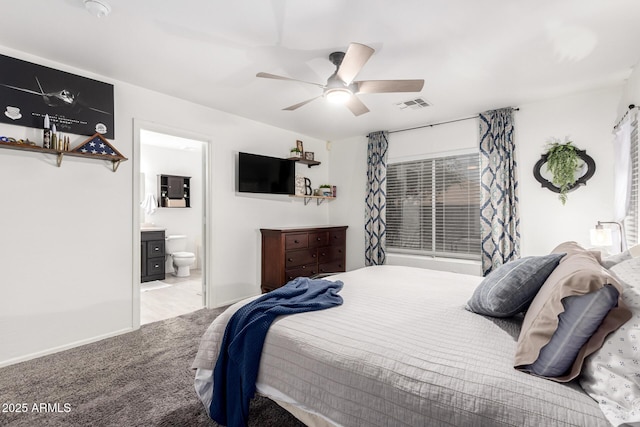 bedroom featuring ceiling fan, connected bathroom, and light carpet