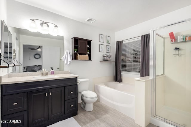 full bathroom featuring ceiling fan, vanity, toilet, and separate shower and tub