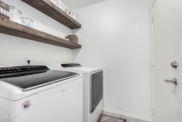 laundry room with independent washer and dryer and hardwood / wood-style floors