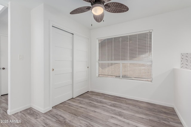 17808 N 45th Ave, Glendale, AZ 85308 - unfurnished bedroom with wood finished floors, a closet, and baseboards