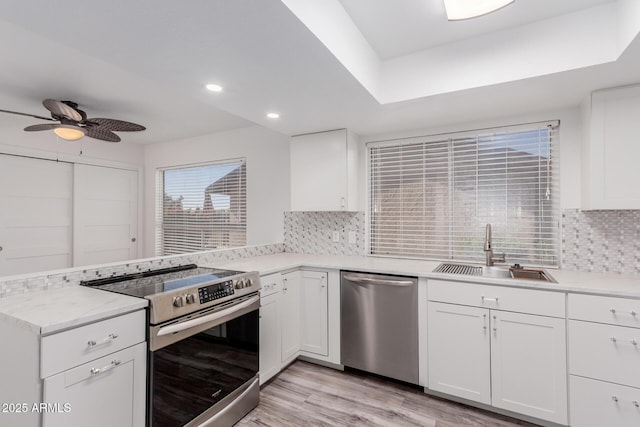 17808 N 45th Ave, Glendale, AZ 85308 - kitchen featuring stainless steel appliances, a sink, a peninsula, tasteful backsplash, and ceiling fan
