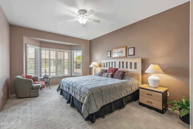 bedroom featuring a ceiling fan and light colored carpet