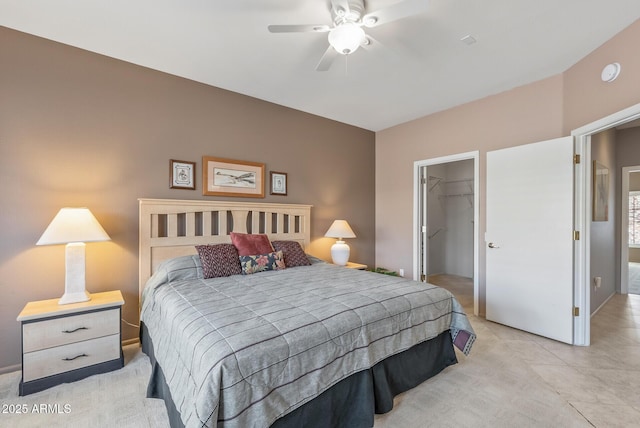 bedroom featuring a spacious closet, a closet, and a ceiling fan