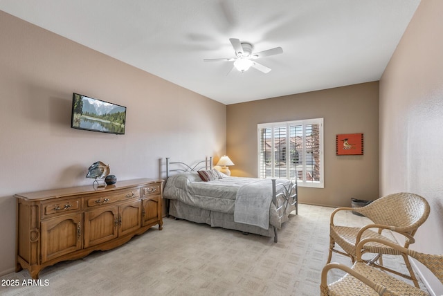 bedroom with a ceiling fan and light carpet