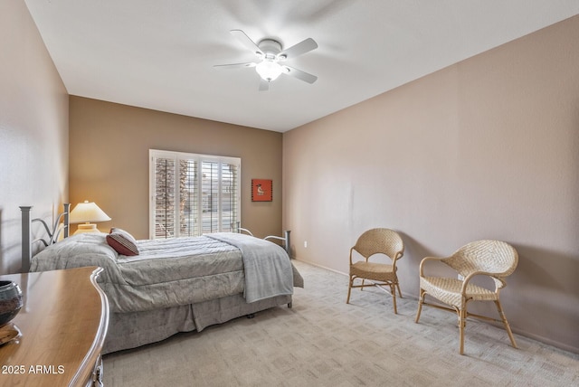 bedroom featuring light carpet and ceiling fan