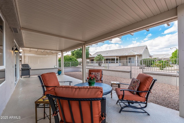 view of patio with fence, outdoor lounge area, and area for grilling