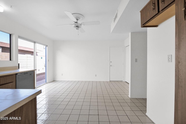 kitchen featuring visible vents, a ceiling fan, stainless steel dishwasher, light countertops, and light tile patterned floors