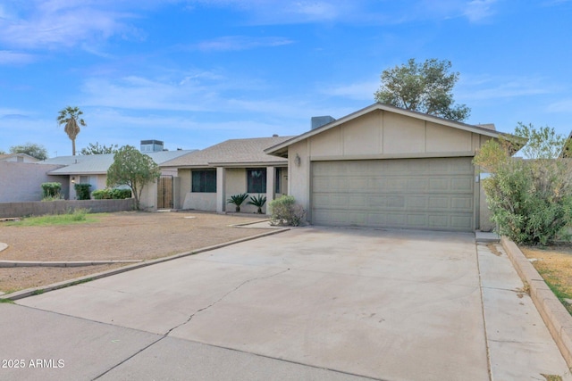 single story home featuring a garage, concrete driveway, and stucco siding