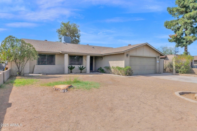 single story home with stucco siding, concrete driveway, an attached garage, and fence