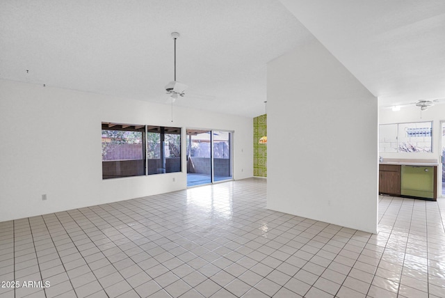 empty room with light tile patterned floors, lofted ceiling, and ceiling fan