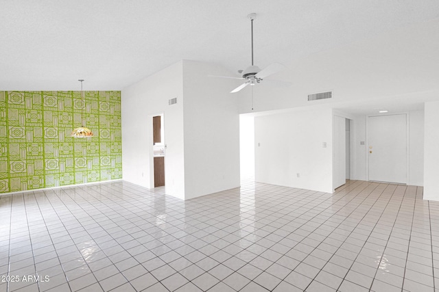 unfurnished room featuring light tile patterned floors, visible vents, high vaulted ceiling, and ceiling fan