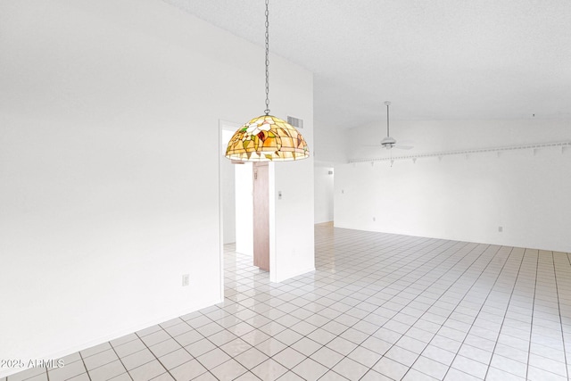 unfurnished room featuring light tile patterned flooring, visible vents, ceiling fan, and vaulted ceiling