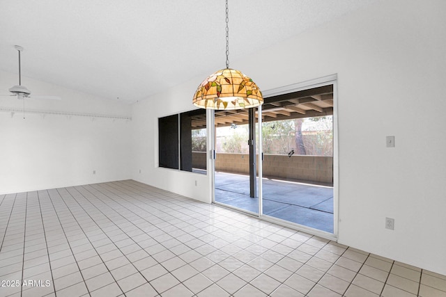 empty room with lofted ceiling, light tile patterned flooring, and a ceiling fan