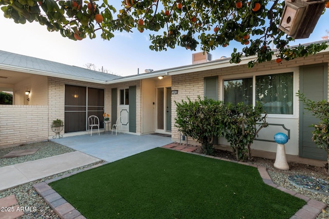 exterior space with a yard and a patio area