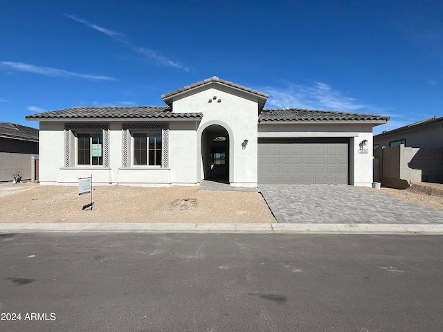 mediterranean / spanish-style house featuring a garage