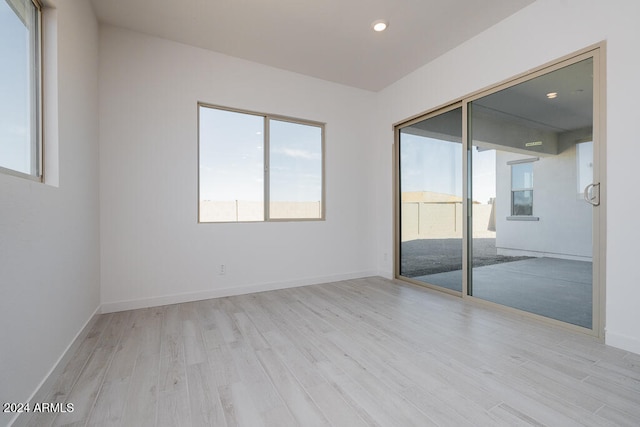 spare room with light hardwood / wood-style flooring