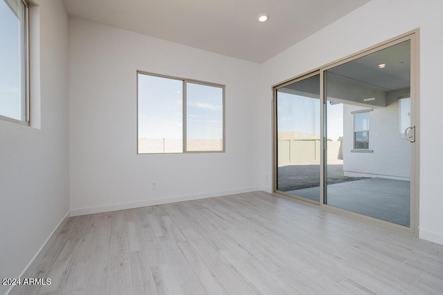 unfurnished room with recessed lighting, baseboards, and wood finished floors
