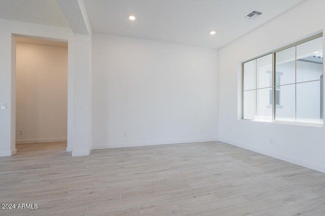 unfurnished room with light wood-type flooring