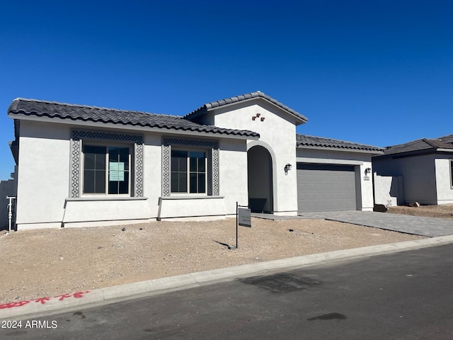 mediterranean / spanish-style home featuring a garage