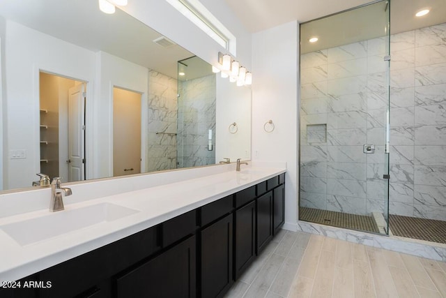 bathroom featuring double vanity, recessed lighting, a sink, and a stall shower