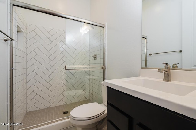 full bath featuring vanity, a stall shower, and toilet