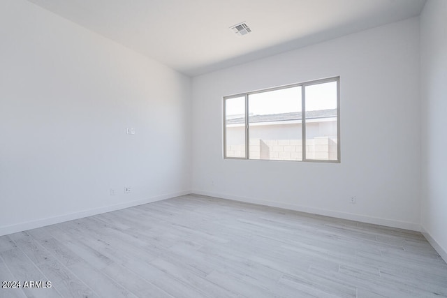 unfurnished room with light hardwood / wood-style floors