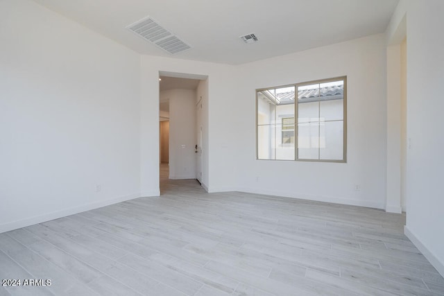 spare room with light wood-type flooring