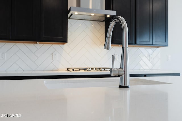 kitchen featuring ventilation hood and backsplash