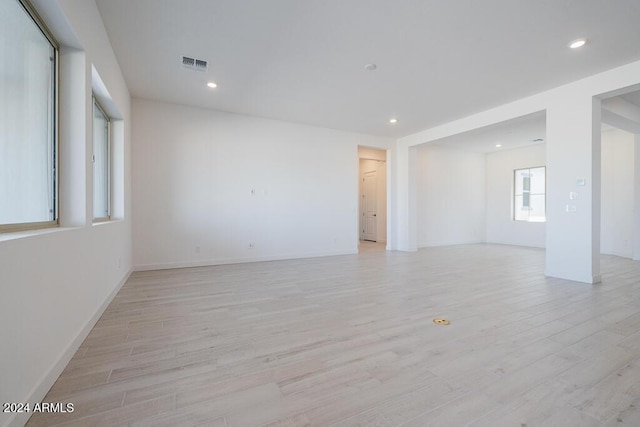 unfurnished room with recessed lighting, baseboards, visible vents, and light wood-style floors