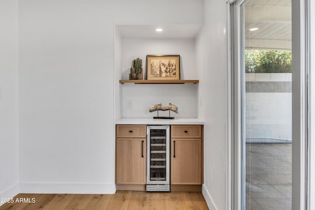 6233 E Pinchot Ave, Scottsdale, AZ 85251 - indoor dry bar featuring beverage cooler, light wood-type flooring, and recessed lighting