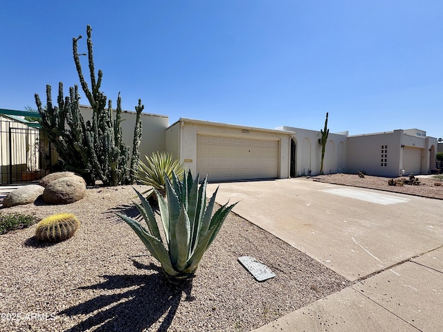 6233 E Pinchot Ave, Scottsdale, AZ 85251 - view of front facade with stucco siding, concrete driveway, and an attached garage