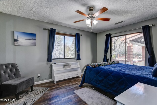 419 Apache Plume Trl, Prescott, AZ 86301 - bedroom with visible vents, baseboards, wood finished floors, a textured ceiling, and a ceiling fan