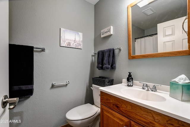 419 Apache Plume Trl, Prescott, AZ 86301 - bathroom with visible vents, toilet, vanity, and a textured wall
