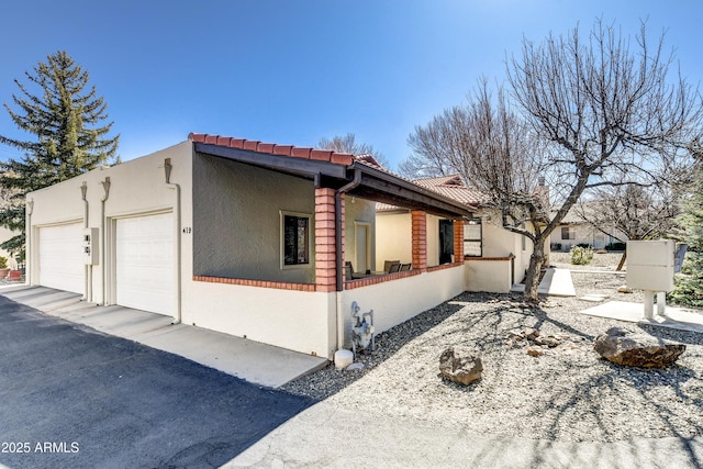 419 Apache Plume Trl, Prescott, AZ 86301 - view of home's exterior featuring stucco siding, an attached garage, and a tile roof