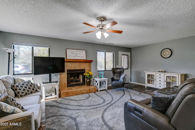 419 Apache Plume Trl, Prescott, AZ 86301 - living area with wood finished floors, a healthy amount of sunlight, ceiling fan, and a fireplace
