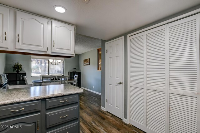 419 Apache Plume Trl, Prescott, AZ 86301 - kitchen with dark wood-type flooring, baseboards, light countertops, gray cabinets, and white cabinetry