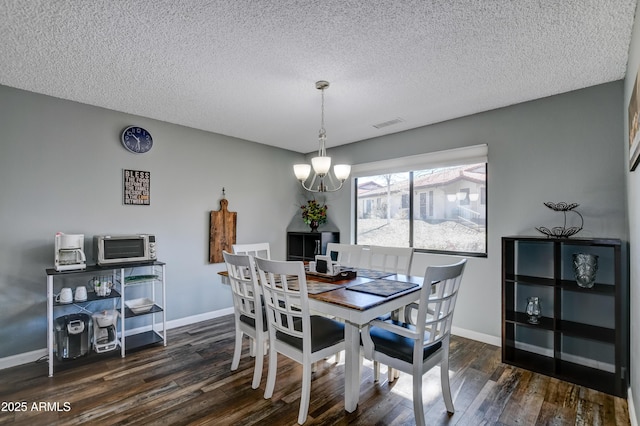 419 Apache Plume Trl, Prescott, AZ 86301 - dining room with baseboards, an inviting chandelier, a toaster, dark wood-type flooring, and a textured ceiling