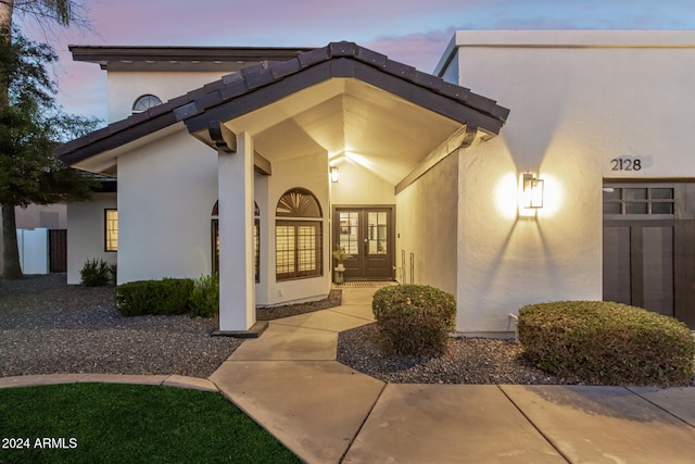 exterior entry at dusk with french doors